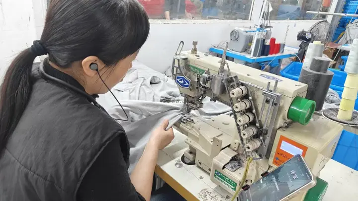 Care label being attached to a garment on the production line