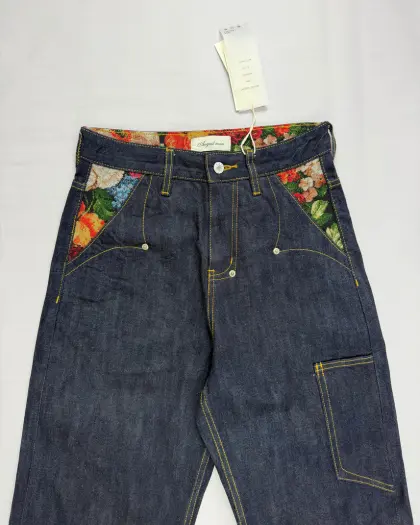 Distressed denim jeans with hand-sanded whisker detailing