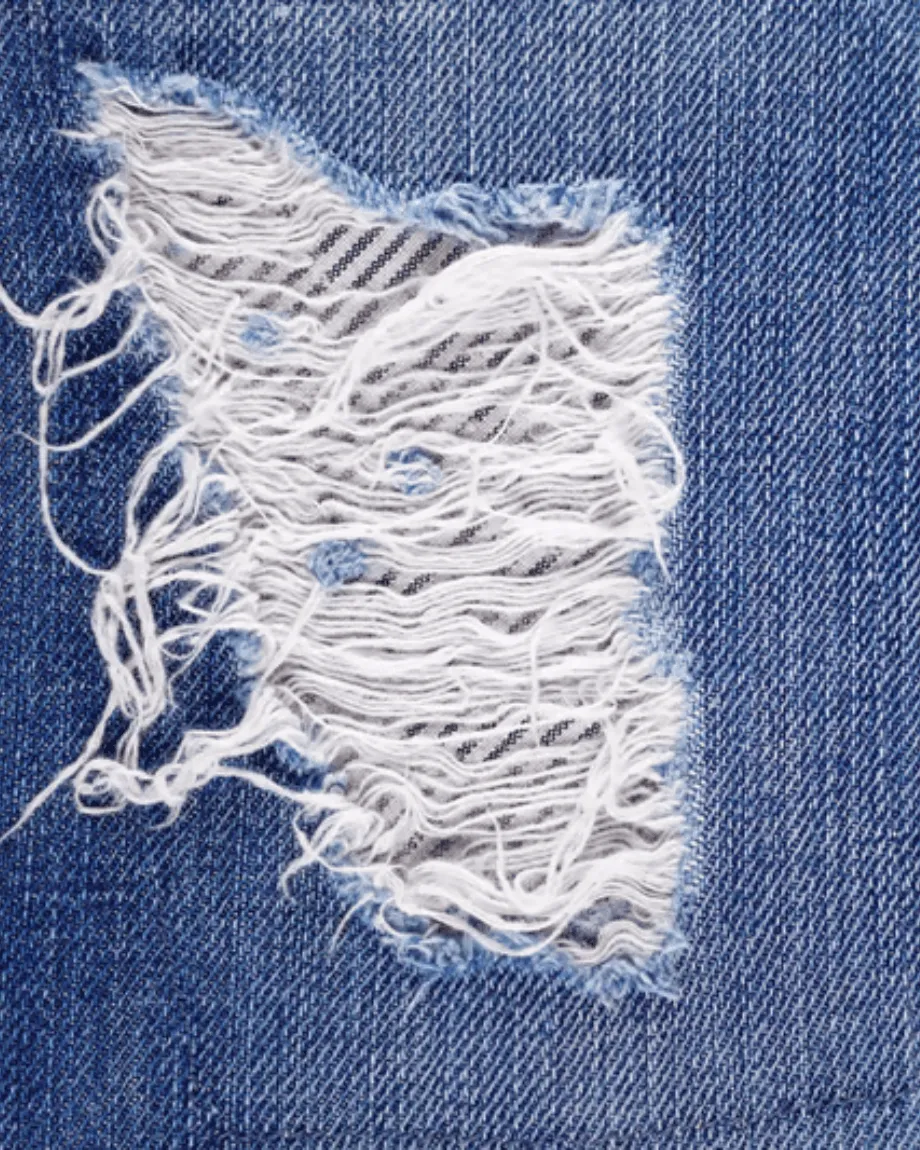 Hand-sanded whisker distressing pattern on denim fabric