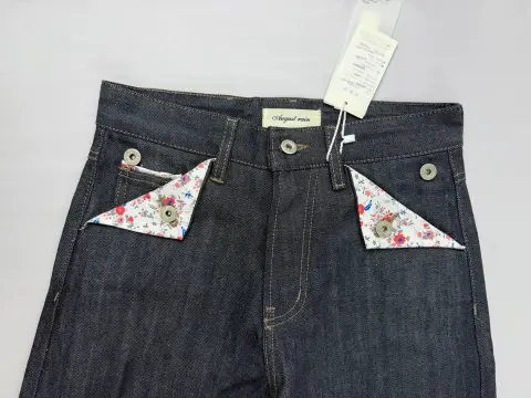 Rolled denim cuff showing the red selvedge ID line along the outseam