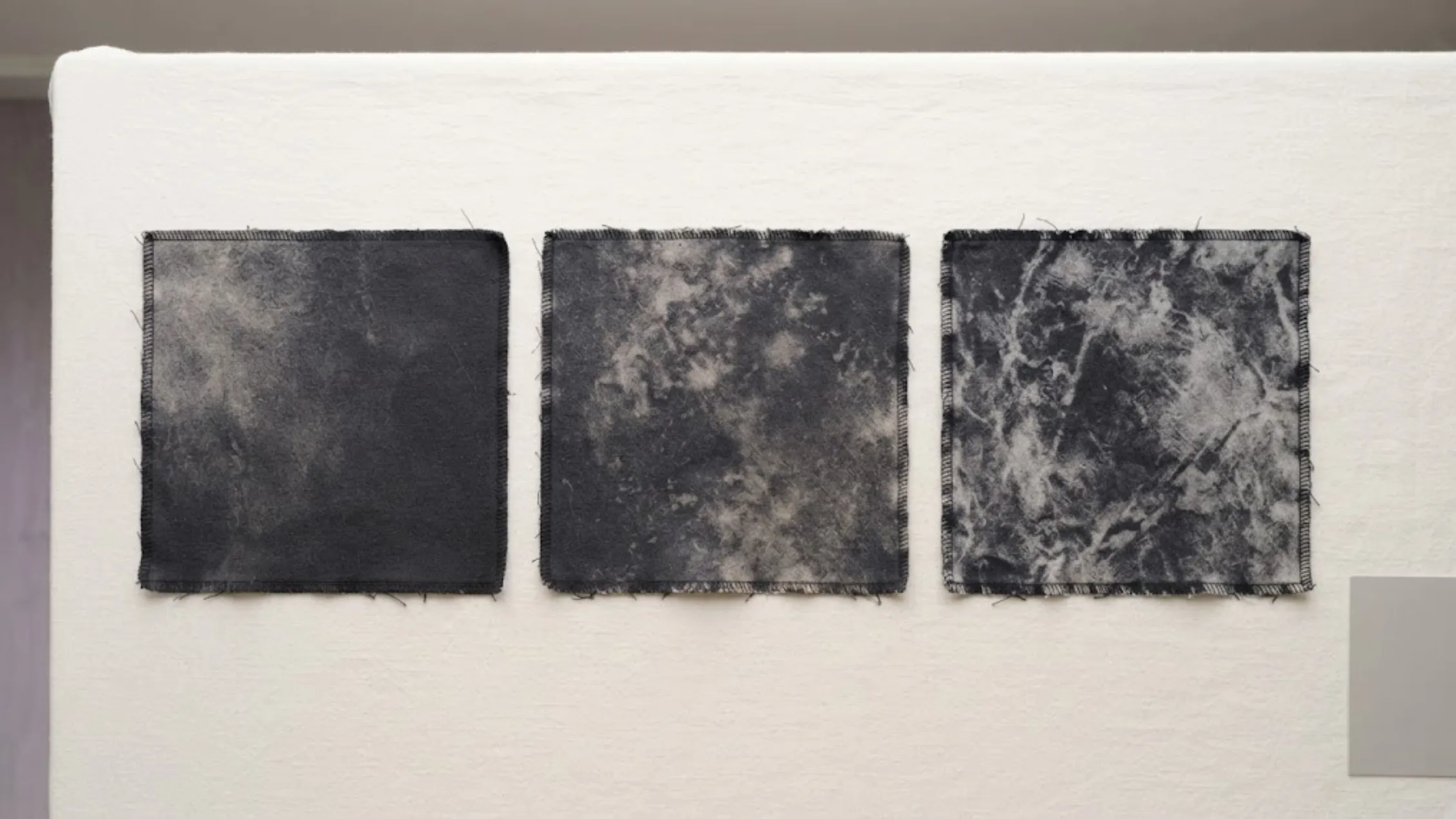 Acid wash grade comparison swatches used to approve a wash level