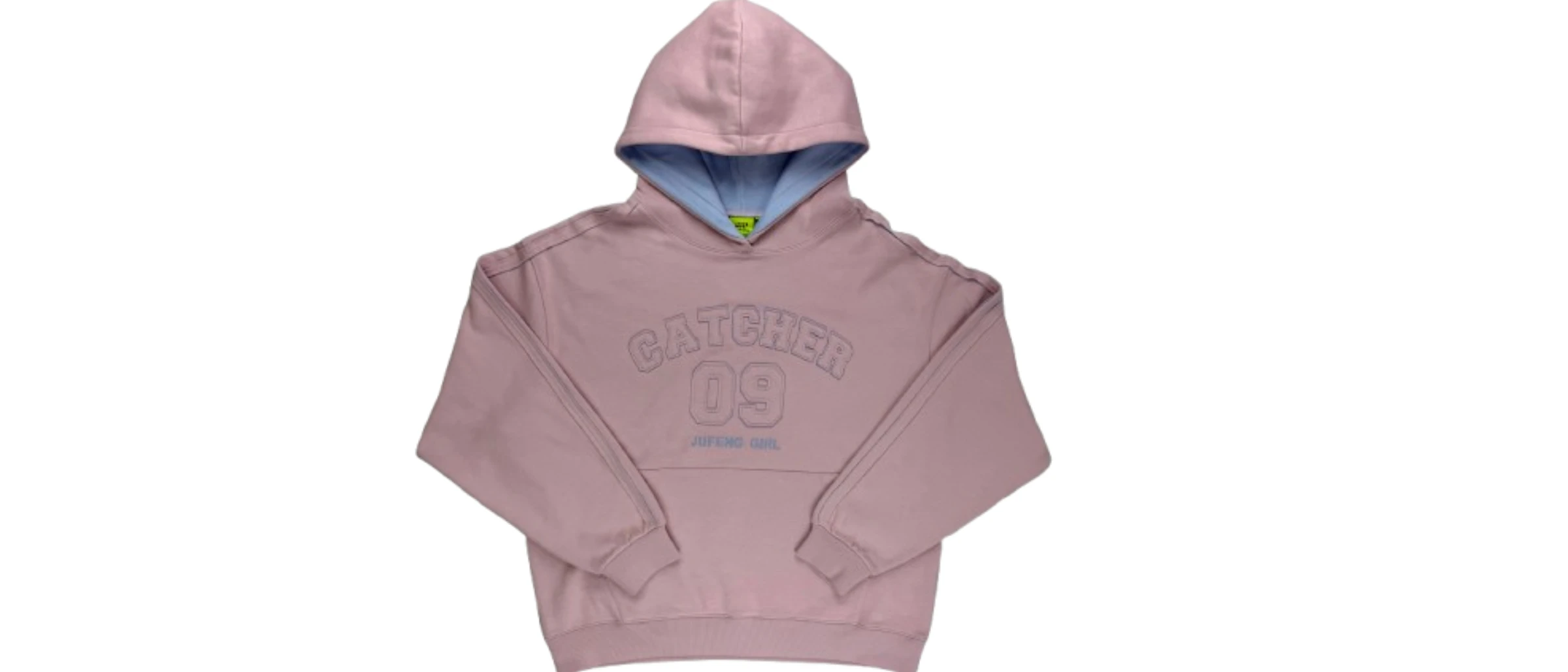 Hoodie development sample laid flat beside a tech pack and fabric swatches