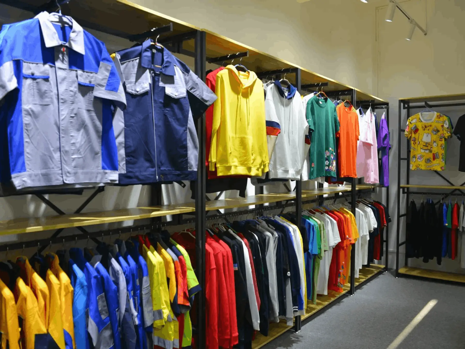 Finished custom streetwear samples displayed on a studio garment rack
