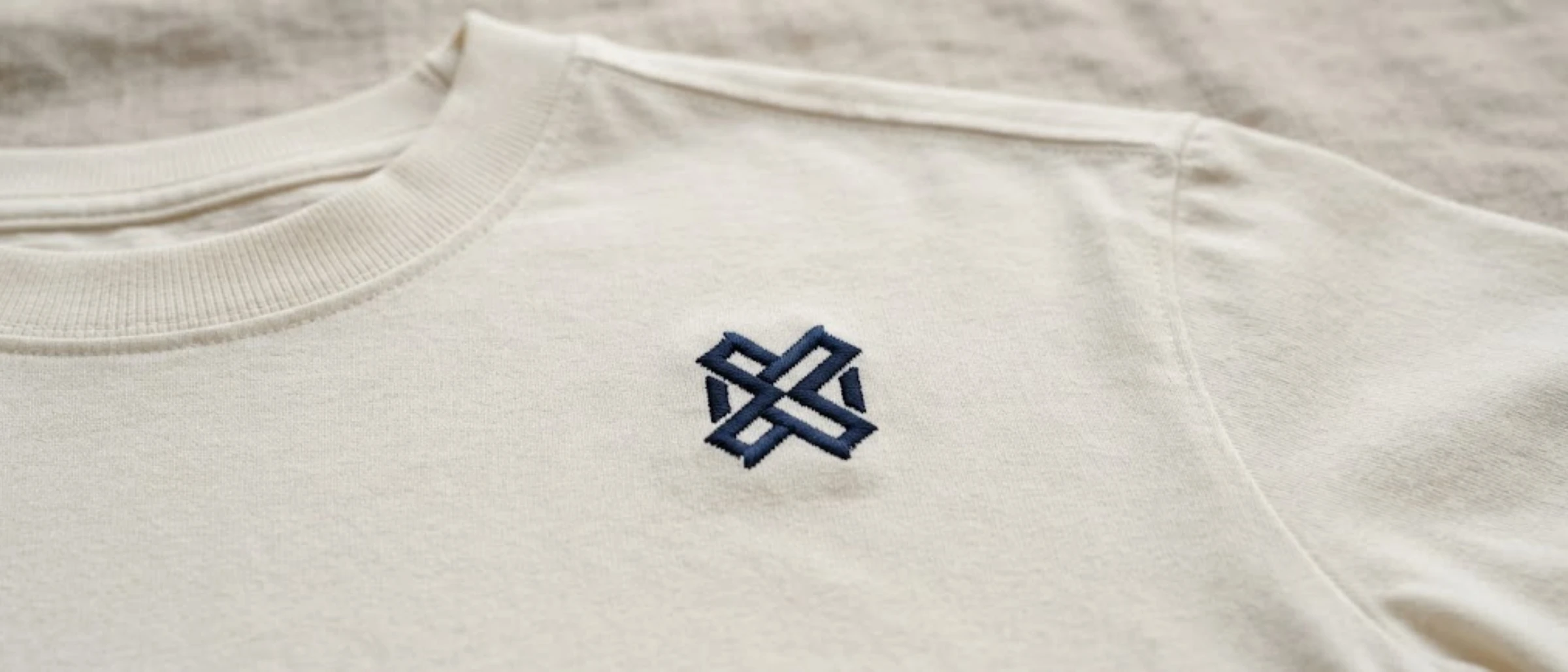 Close-up of an embroidered chest logo on a finished custom t-shirt