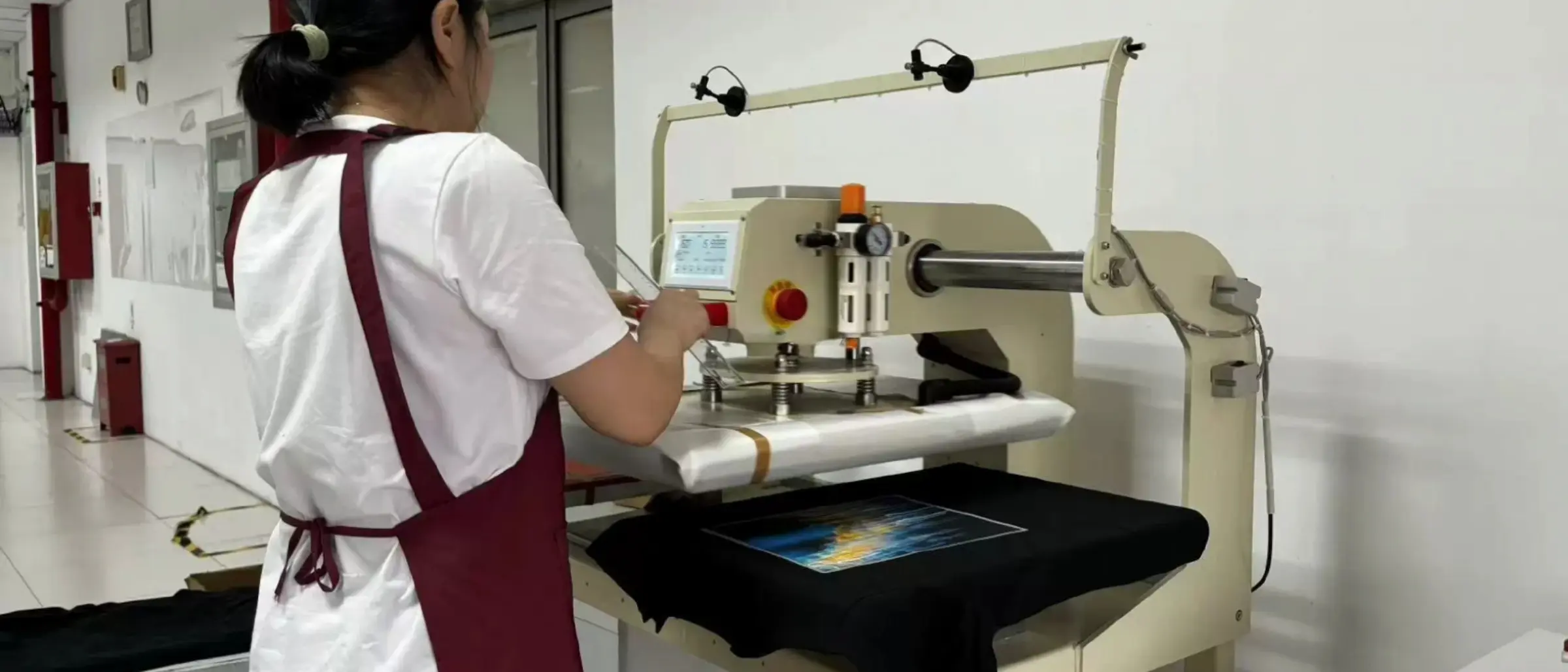Illustration of a heat press with a rhinestone transfer aligned on a hoodie panel
