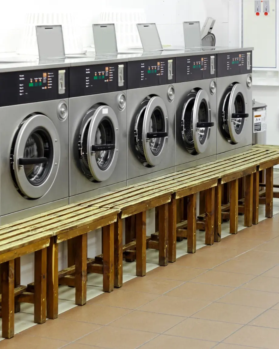Industrial washing machines mid-cycle running an acid wash batch of garments