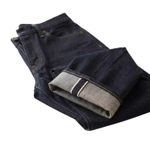 Dark indigo raw selvedge jeans with a turned-up red-line selvedge cuff