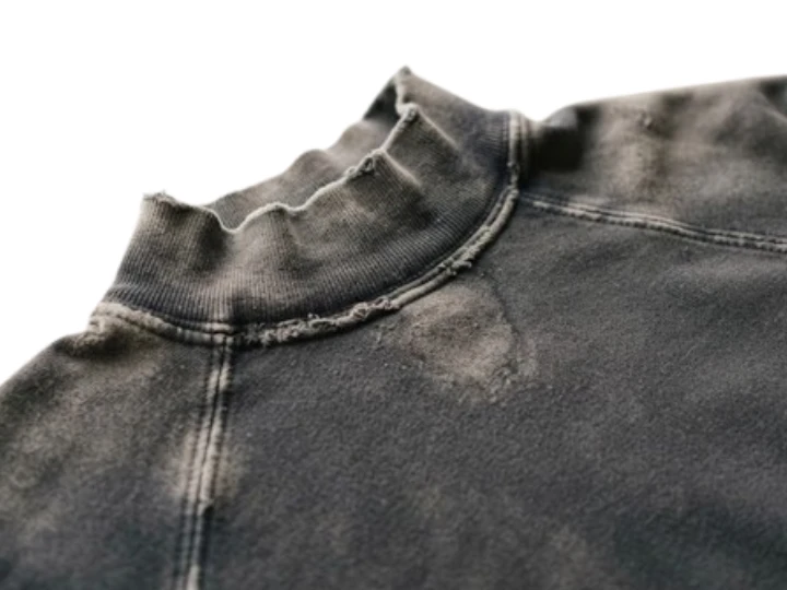 Vintage wash hoodie showing worn fade detail concentrated at collar and seams