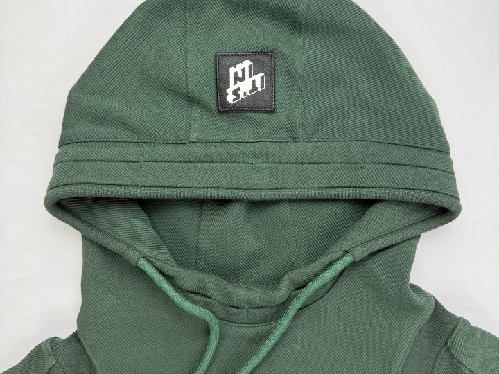 Light vintage wash distressing showing subtle fading at hoodie collar