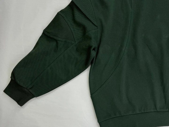 Medium vintage wash distressing showing fading and sanding at hoodie cuffs